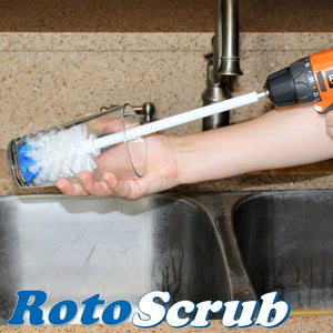 An extended reach bottle brush, attached to a Rigid drill, cleaning a drinking glass in the kitchen sink..